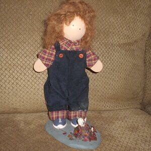 Wooden Doll with Pet Standing on Rock